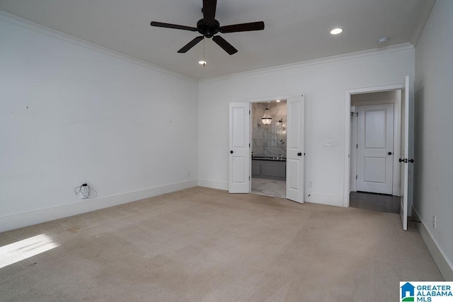 unfurnished bedroom featuring connected bathroom, light colored carpet, ceiling fan, and ornamental molding