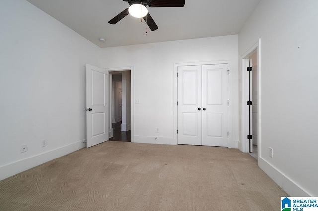 unfurnished bedroom with a closet, ceiling fan, and light colored carpet