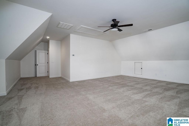 additional living space featuring ceiling fan, light carpet, and vaulted ceiling