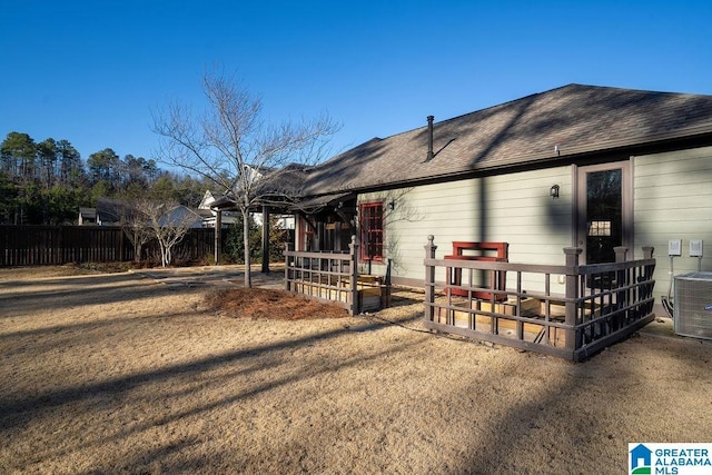 rear view of property with central AC