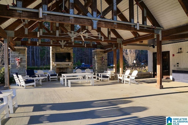 view of patio / terrace with a gazebo, ceiling fan, and an outdoor living space with a fireplace