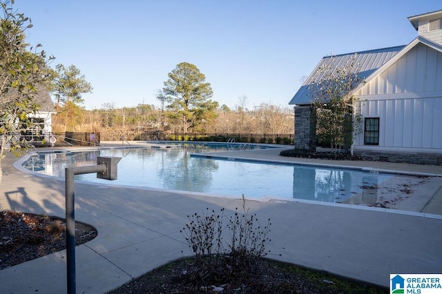 view of swimming pool featuring a patio area