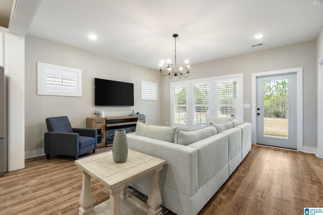 living room featuring hardwood / wood-style floors and an inviting chandelier