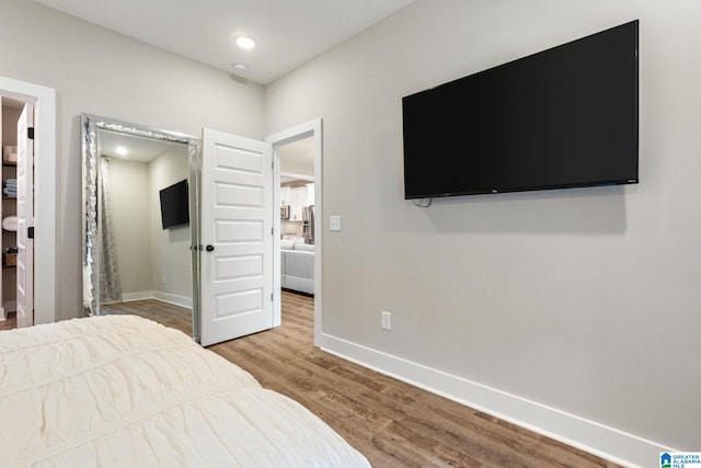 bedroom with wood-type flooring