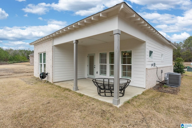 back of house featuring a yard, cooling unit, and a patio