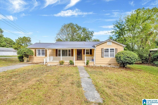 ranch-style home featuring a porch and a front yard