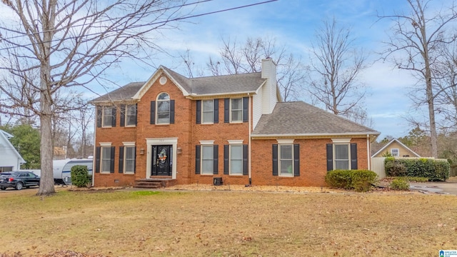 colonial inspired home with a front yard