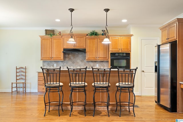 kitchen with stainless steel refrigerator with ice dispenser, crown molding, light hardwood / wood-style floors, oven, and hanging light fixtures