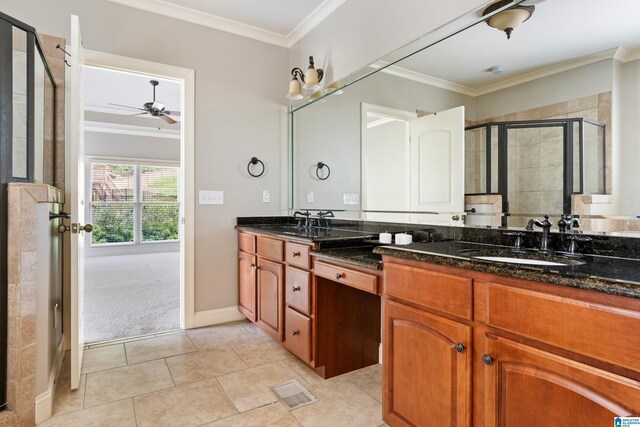 bathroom with vanity, tile patterned floors, crown molding, ceiling fan, and a shower with shower door