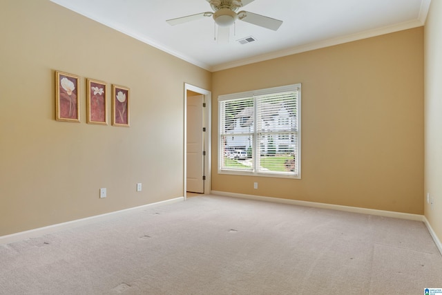 carpeted spare room featuring ceiling fan and ornamental molding