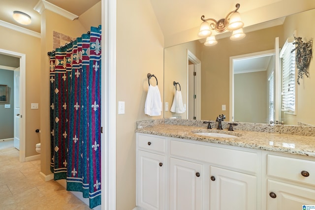 bathroom featuring vanity, toilet, and crown molding