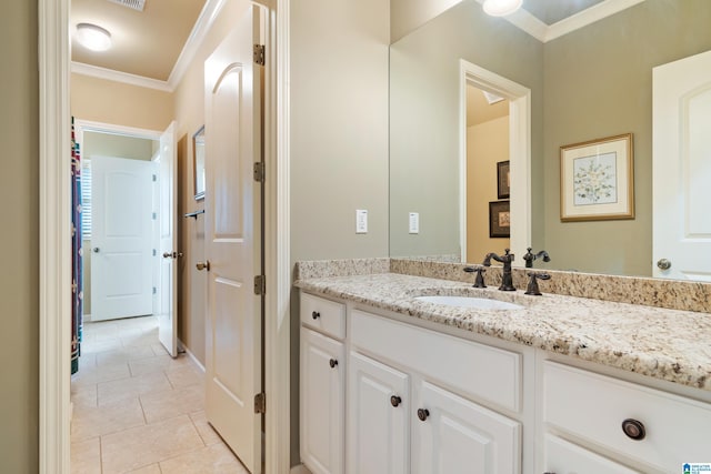 bathroom featuring tile patterned flooring, vanity, and crown molding