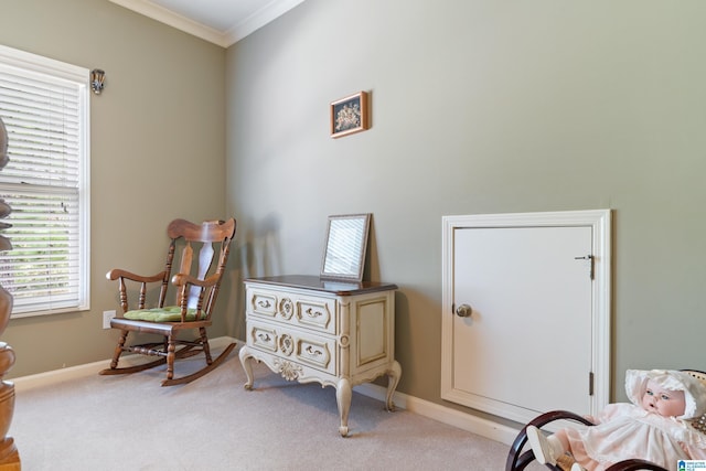 sitting room featuring light colored carpet and ornamental molding