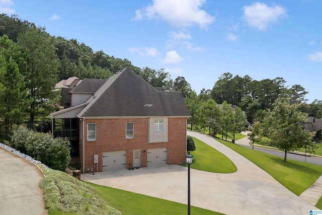 view of home's exterior with a yard and a garage