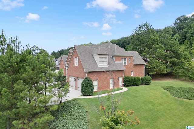 view of side of property featuring a garage and a yard