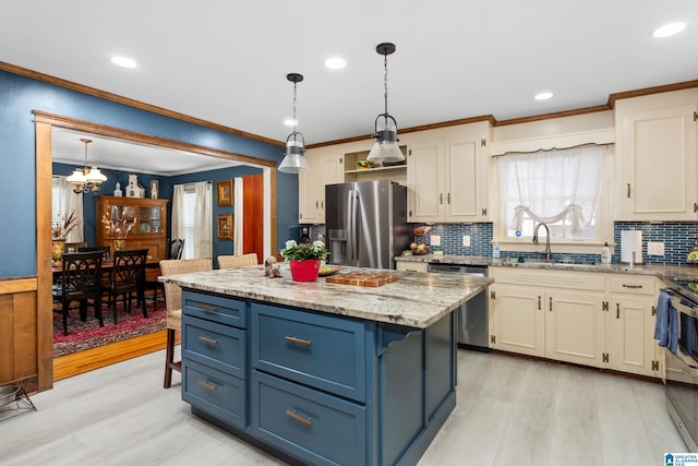 kitchen featuring a center island, light wood-type flooring, hanging light fixtures, and appliances with stainless steel finishes