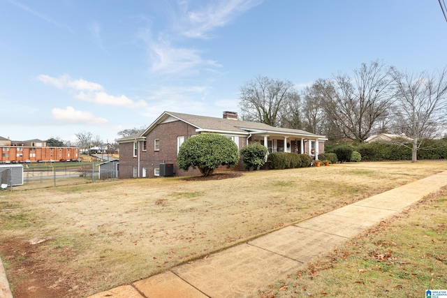 ranch-style home with covered porch, a front yard, and central AC