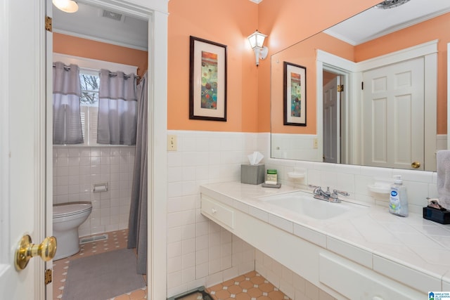 bathroom featuring sink, tile patterned flooring, toilet, tile walls, and ornamental molding