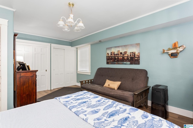 bedroom with dark hardwood / wood-style flooring, crown molding, and an inviting chandelier