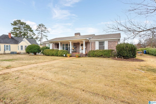 view of front of home with covered porch, a front lawn, and cooling unit