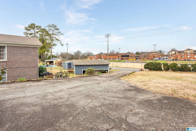 view of yard featuring central AC unit and a storage unit