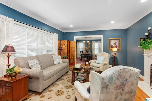 living room with ornamental molding, light hardwood / wood-style floors, and a notable chandelier