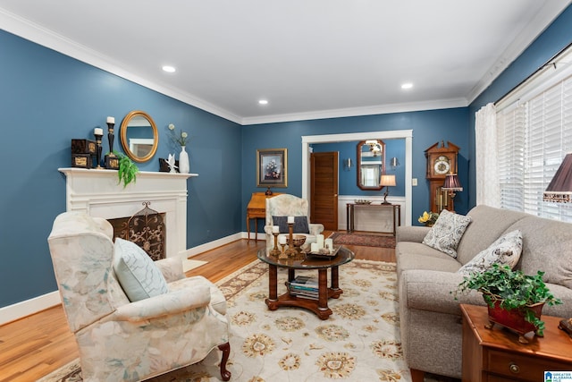 living room featuring a high end fireplace, light wood-type flooring, and ornamental molding