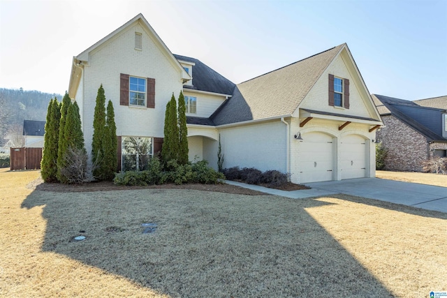 front facade featuring a garage and a front lawn