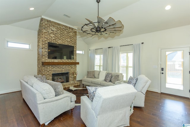 living room featuring lofted ceiling, ceiling fan, a fireplace, and dark hardwood / wood-style floors