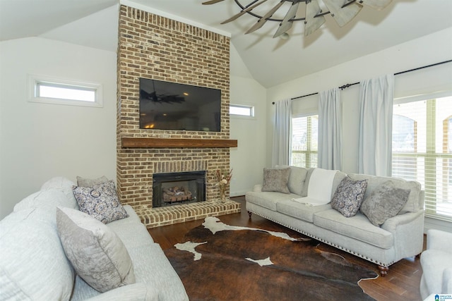 living room with wood-type flooring, a fireplace, and vaulted ceiling