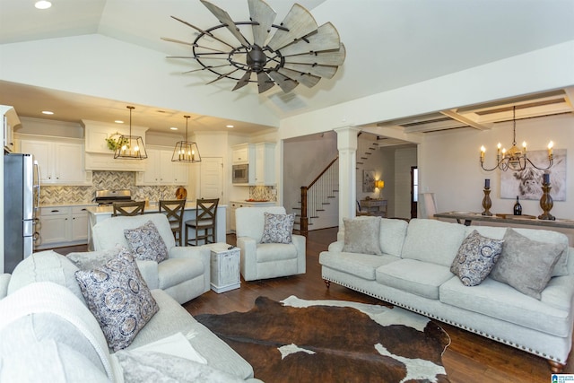 living room with decorative columns, dark hardwood / wood-style flooring, and lofted ceiling with beams