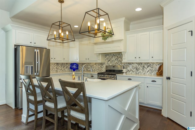 kitchen featuring white cabinetry, sink, pendant lighting, and appliances with stainless steel finishes