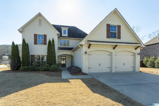 view of front of property with a garage and a front lawn