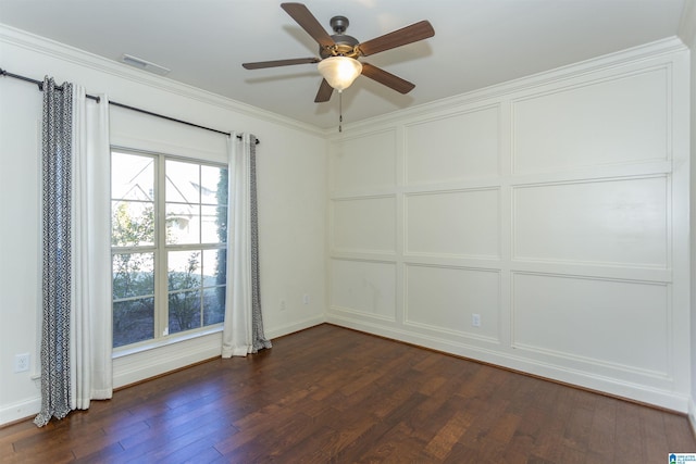 empty room with ornamental molding, ceiling fan, and dark wood-type flooring