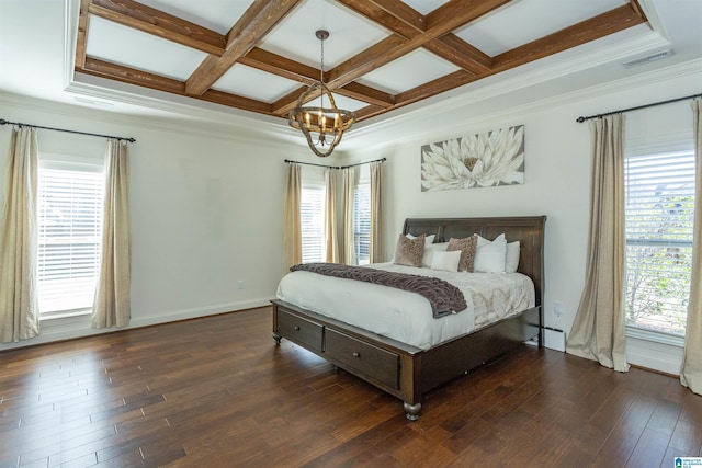 bedroom with multiple windows, coffered ceiling, and a notable chandelier