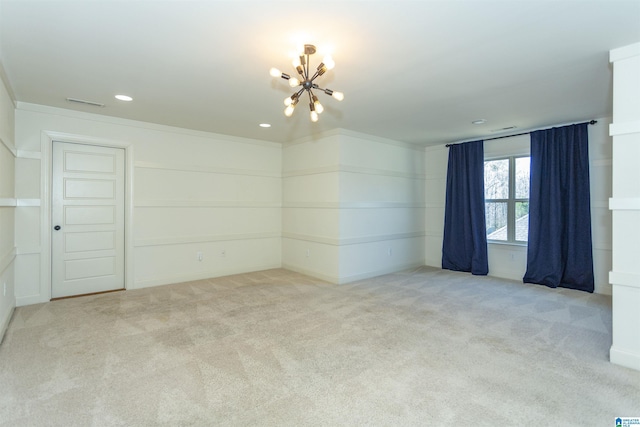 carpeted empty room with an inviting chandelier