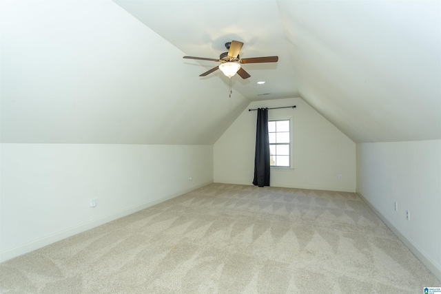 bonus room with light colored carpet, vaulted ceiling, and ceiling fan