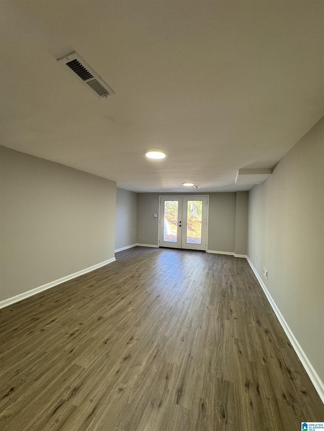 unfurnished room with french doors and dark hardwood / wood-style flooring