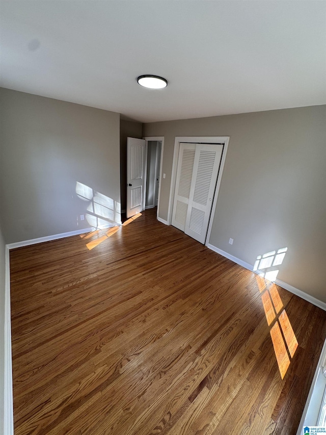 interior space with a closet and dark hardwood / wood-style flooring