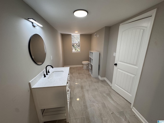 bathroom with toilet and vanity