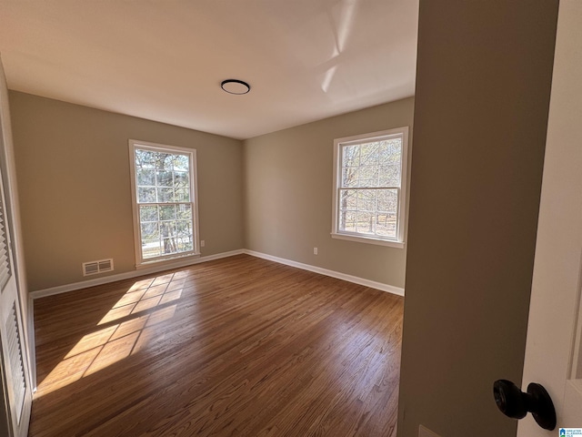 spare room featuring dark wood-type flooring