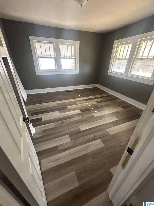 empty room featuring hardwood / wood-style flooring and a healthy amount of sunlight