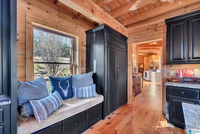 mudroom with beam ceiling, light wood-type flooring, wood ceiling, and wood walls