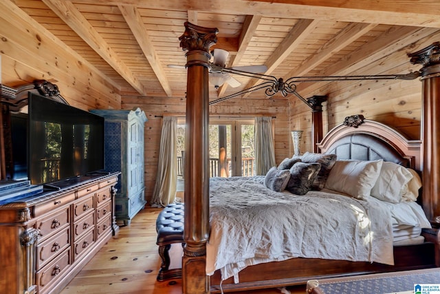 bedroom featuring beam ceiling, light hardwood / wood-style floors, access to outside, wooden walls, and wood ceiling