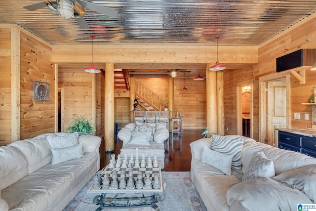 living room featuring wood walls, ceiling fan, and wood ceiling