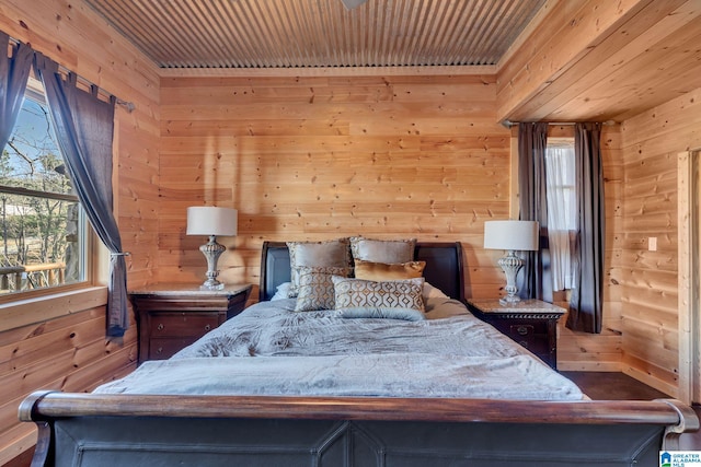 bedroom featuring wood walls and wood ceiling