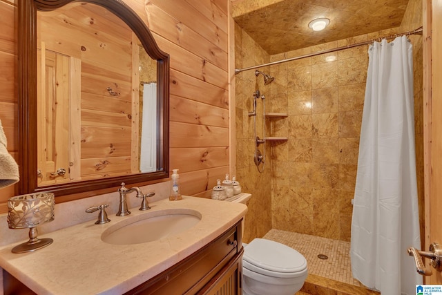 bathroom with wood walls, toilet, vanity, and a shower with shower curtain