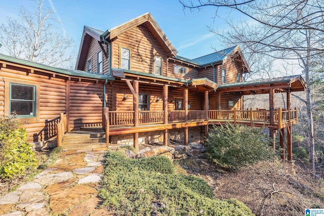 rear view of house featuring a porch