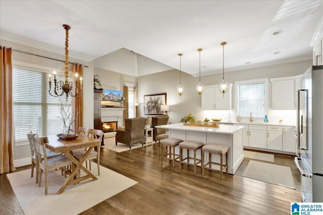 dining room with dark hardwood / wood-style flooring, crown molding, and sink