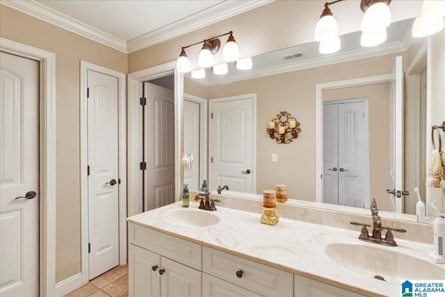 bathroom with tile patterned floors, crown molding, and vanity